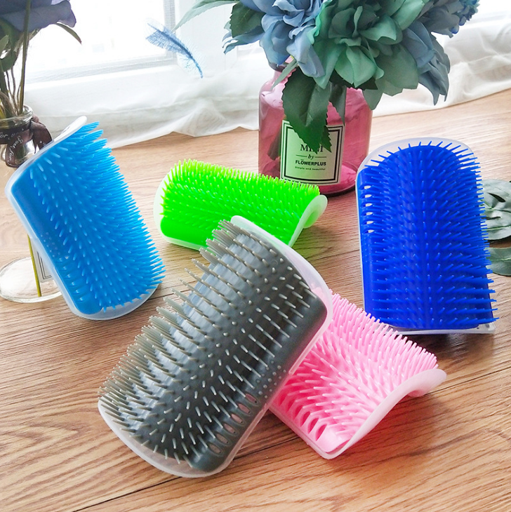 Self-grooming cat brush mounted in corner with soft bristles