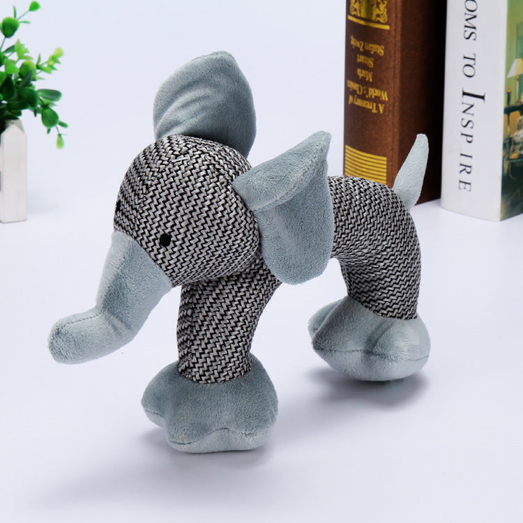 Small dog playing with elephant squeaky plush chew toy
