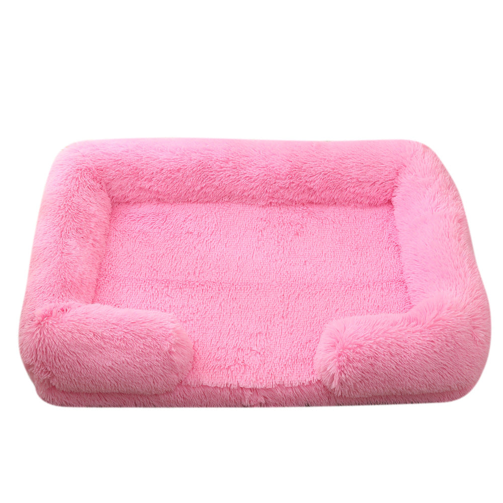 Cat sleeping in plush rectangular winter bed